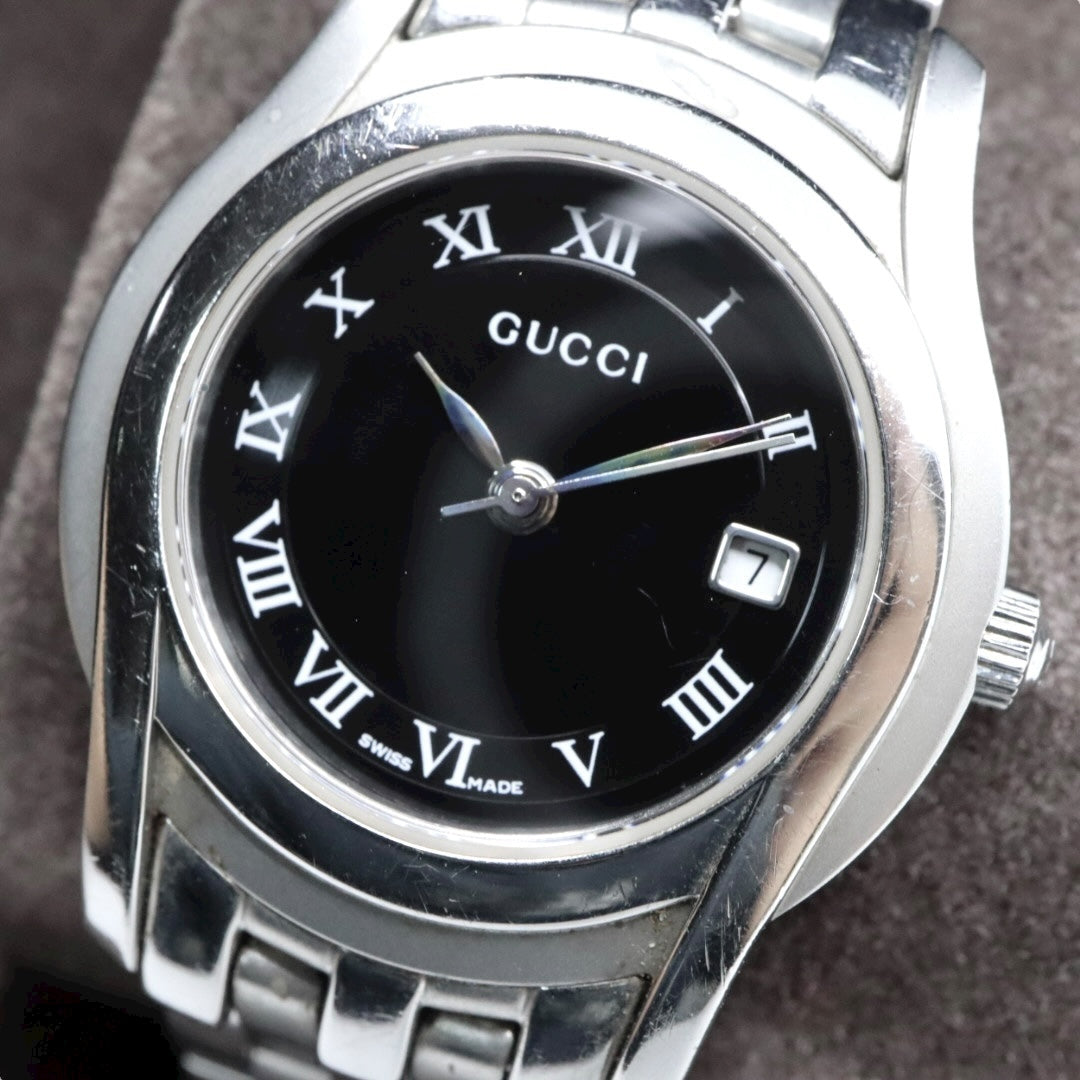 GUCCI グッチ 5500L レディース腕時計 ブラック文字盤 ローマンインデックス デイト ステンレススチール クォーツ スイス製 リンクブレス G11