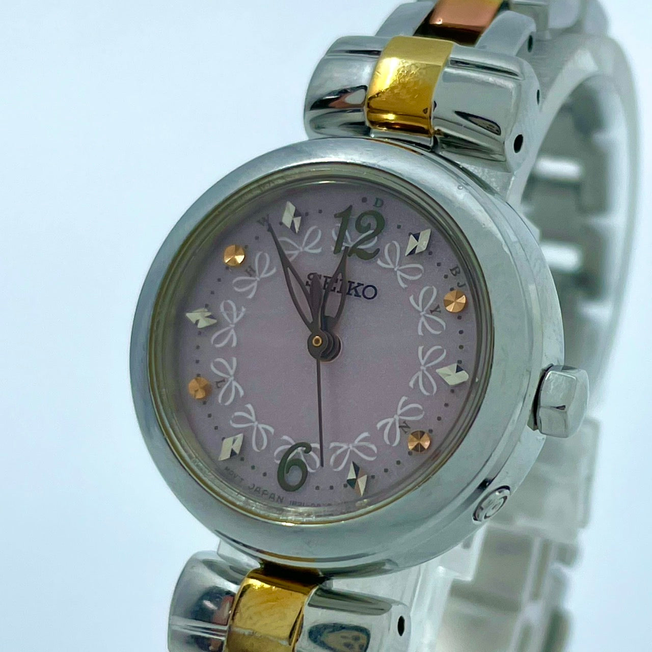 【稼働品／美品】セイコー 腕時計 1B21-0AK0 レディース 電波ソーラー ピンク文字盤 リボン柄 シルバー ゴールド コンビカラー アナログ ラウンド フェミニン エレガント かわいい ビジネス オフィス クリーニング済み G5